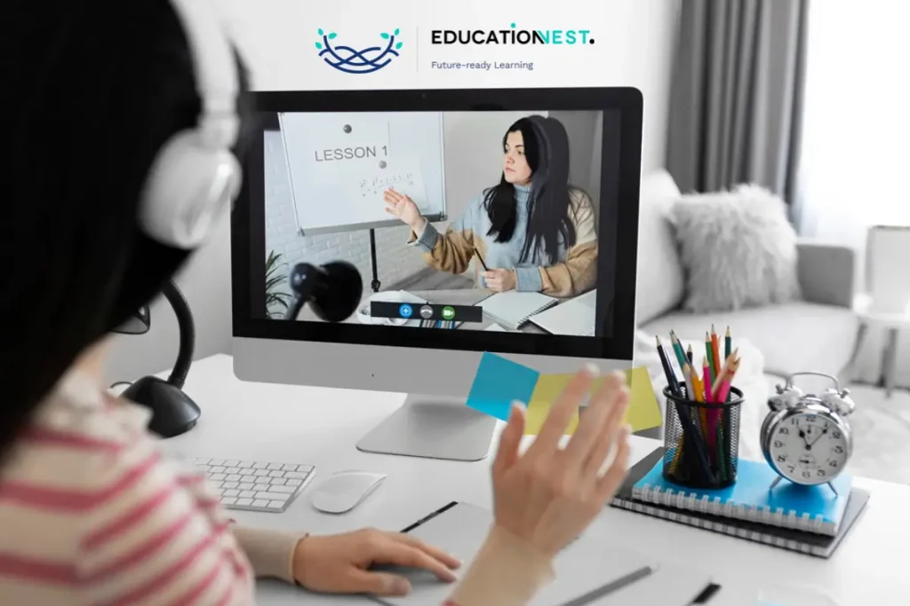 A woman instructs a remote class on a computer, training Salesforce teams in India.