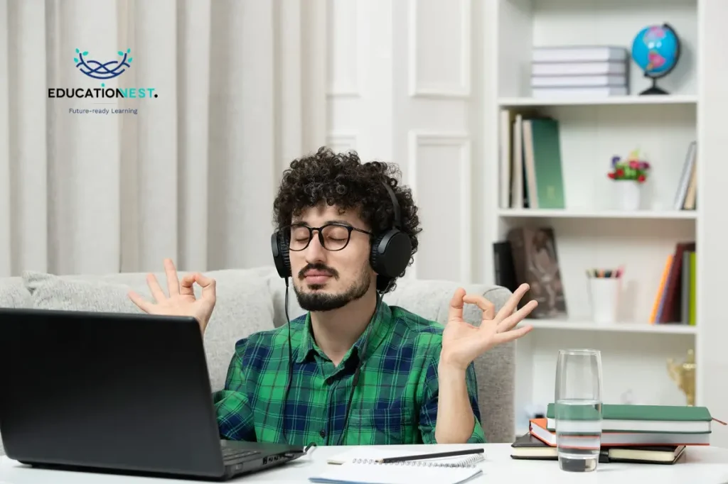 A man with headphones sits at a desk, focused on his laptop, embodying stress management for remote workers.