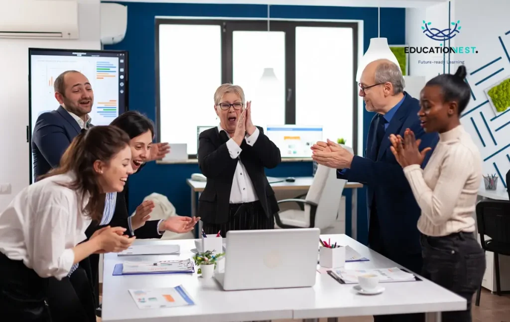 A diverse group of entry-level employees in an office enthusiastically raises their hands, symbolizing engagement in leadership development.