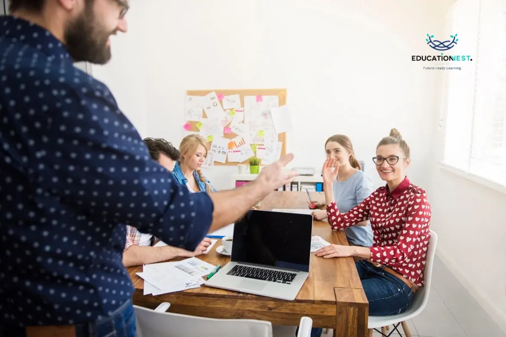 A man presents to colleagues, sharing insights on employee development strategies in a professional setting.