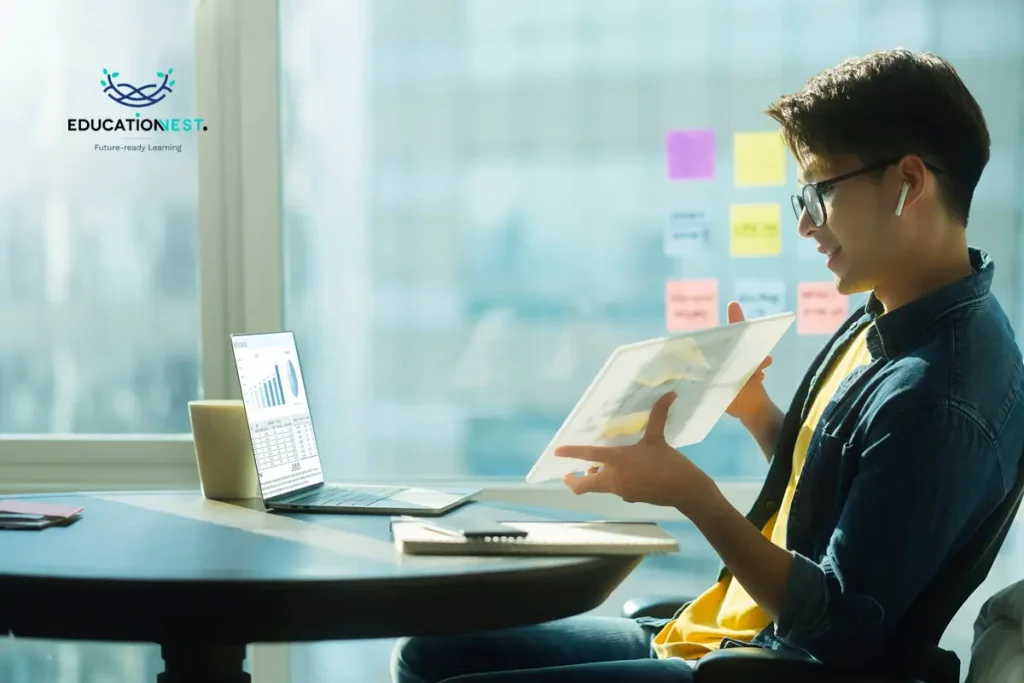 A man engaged with a laptop and a book at his desk, illustrating effective strategies for using Microsoft Copilot.