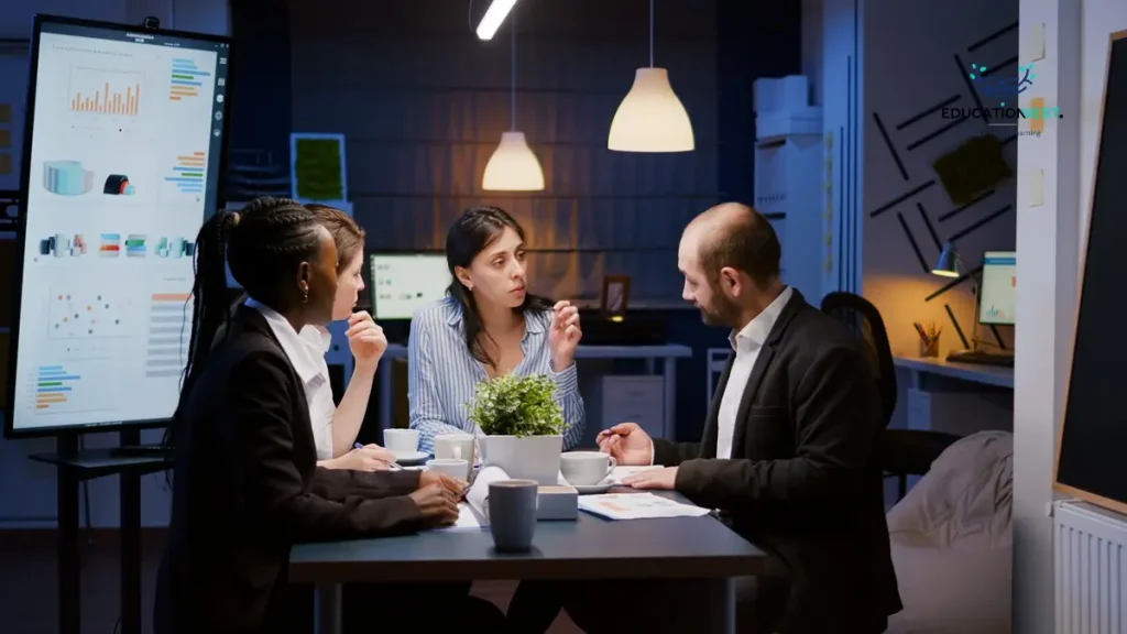 Three business leaders seated at a conference table in an office, strategizing on building a leadership pipeline.