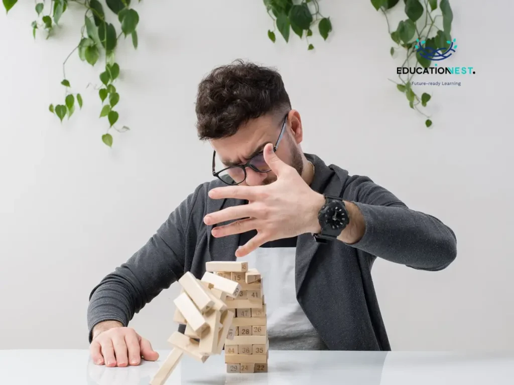 A man plays with wooden blocks on a table, highlighting the importance of tactile learning in identifying skill gaps.