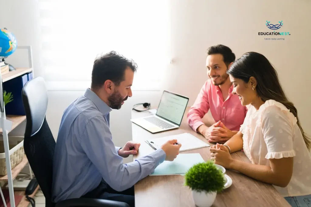 A man and woman collaborate at a desk with a laptop, discussing financial wellness programs for employees.