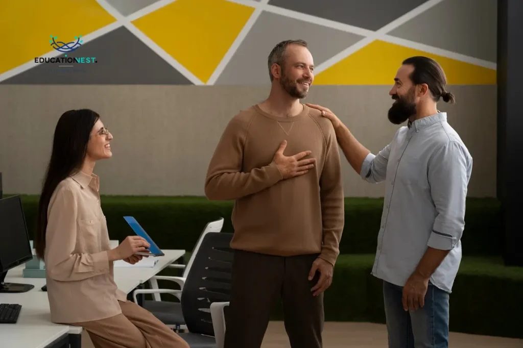 Three individuals conversing in an office, highlighting the critical role of feedback in fostering employee development.