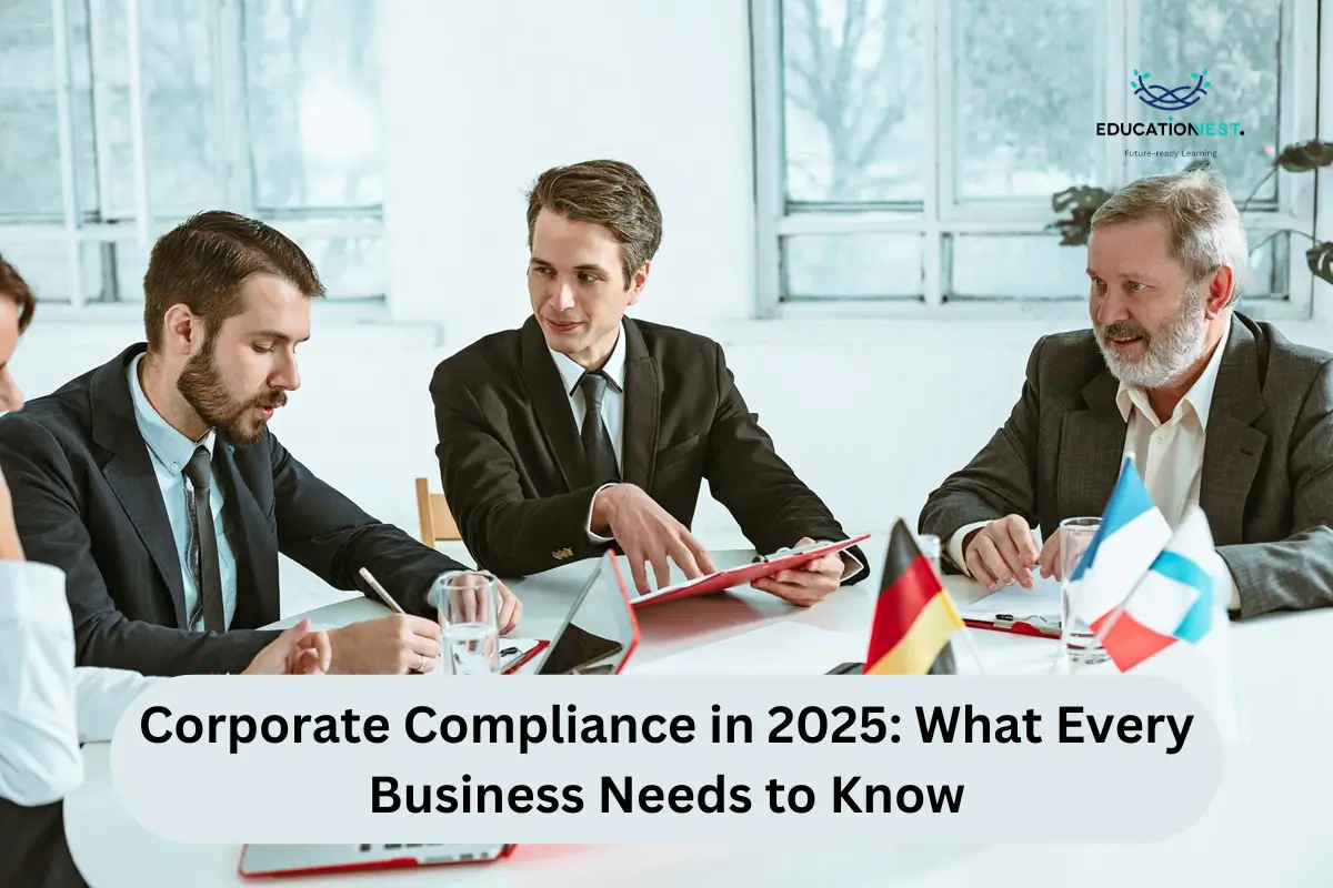 A group of four business individuals engaged in discussion at a table, focused on a laptop regarding 2025 corporate compliance.