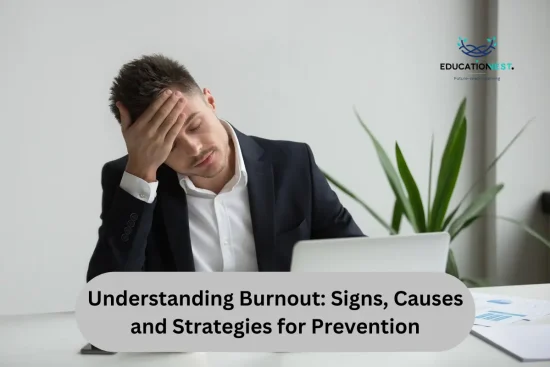 A man in a suit sits at a desk, visibly stressed, with his head in his hands, illustrating the impact of burnout.