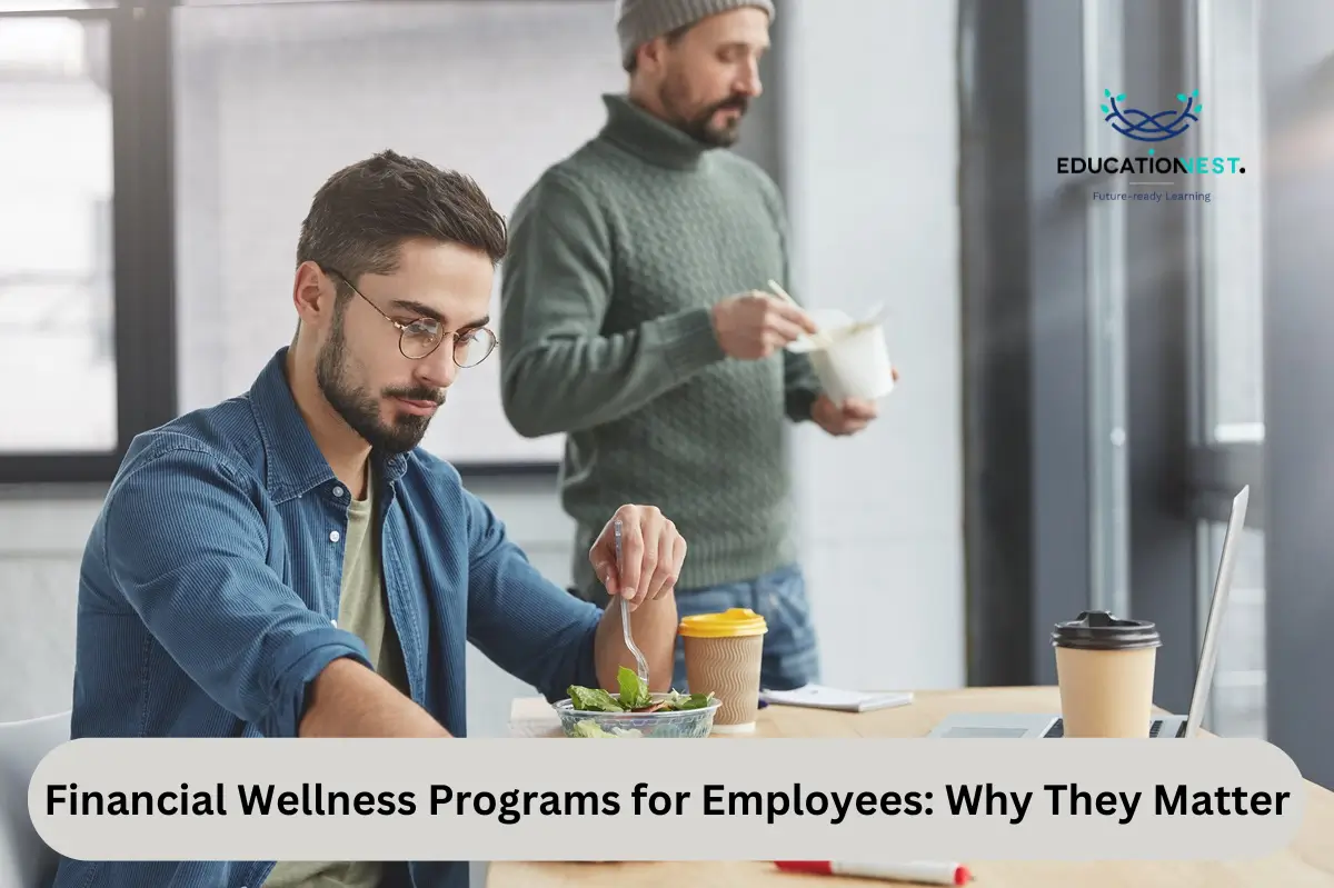 Two men work together with a laptop, emphasizing the significance of financial wellness programs for employees.