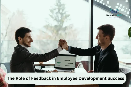 Two men shaking hands at a table, symbolizing collaboration and the importance of feedback in employee development.