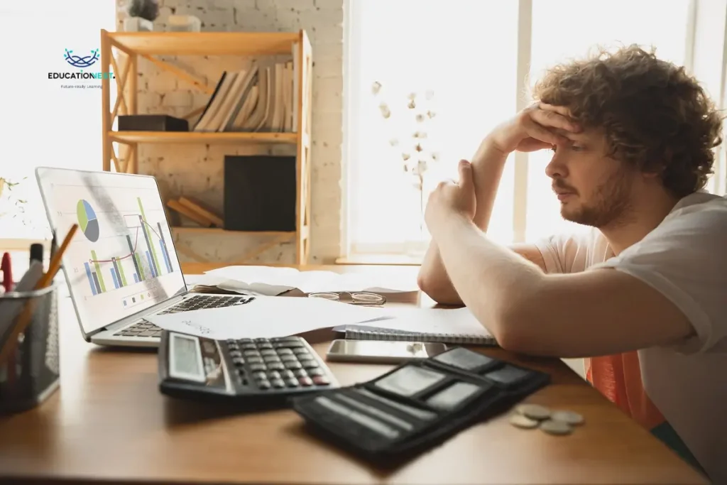 A man sitting at his desk, head in hands, illustrating the struggles faced in why most accountability programs fail.