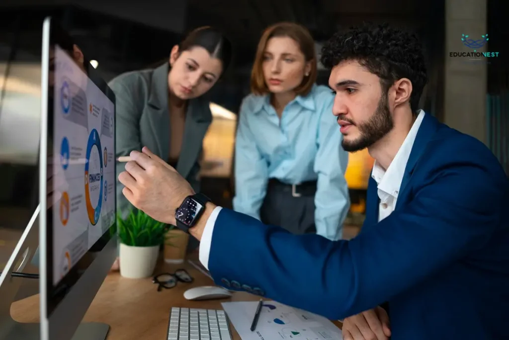 A trio of business individuals collaborating over a computer screen, focused on employee training hacks.