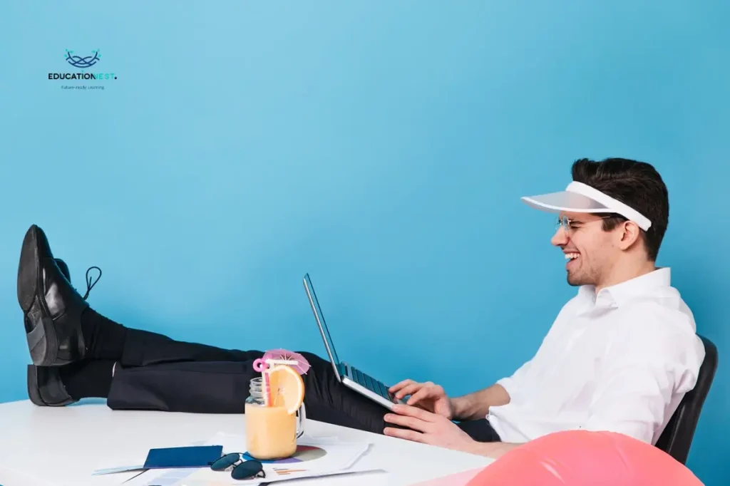 A man in a hat sits at a desk, focused on his laptop, representing remote work and employee engagement games.