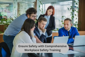 Employees engaged in a Workplace Safety Training session, collaborating around a laptop in a modern office setting, focused on safety protocols and compliance.