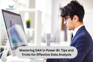 A man in a suit analyzes a chart displayed on a computer screen, focusing on data analysis techniques in Power BI.