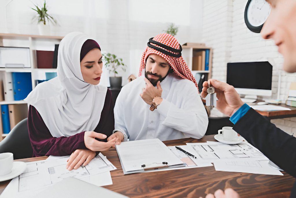 Arabic couple discussing business strategies in an office setting, with a focus on a Kuwait job vacancy opportunity.